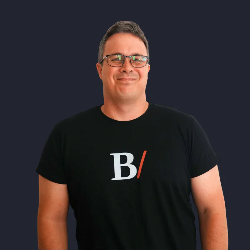Jethro Pickering, co-founder of Built With Skills, smiling in a black logo T-shirt
